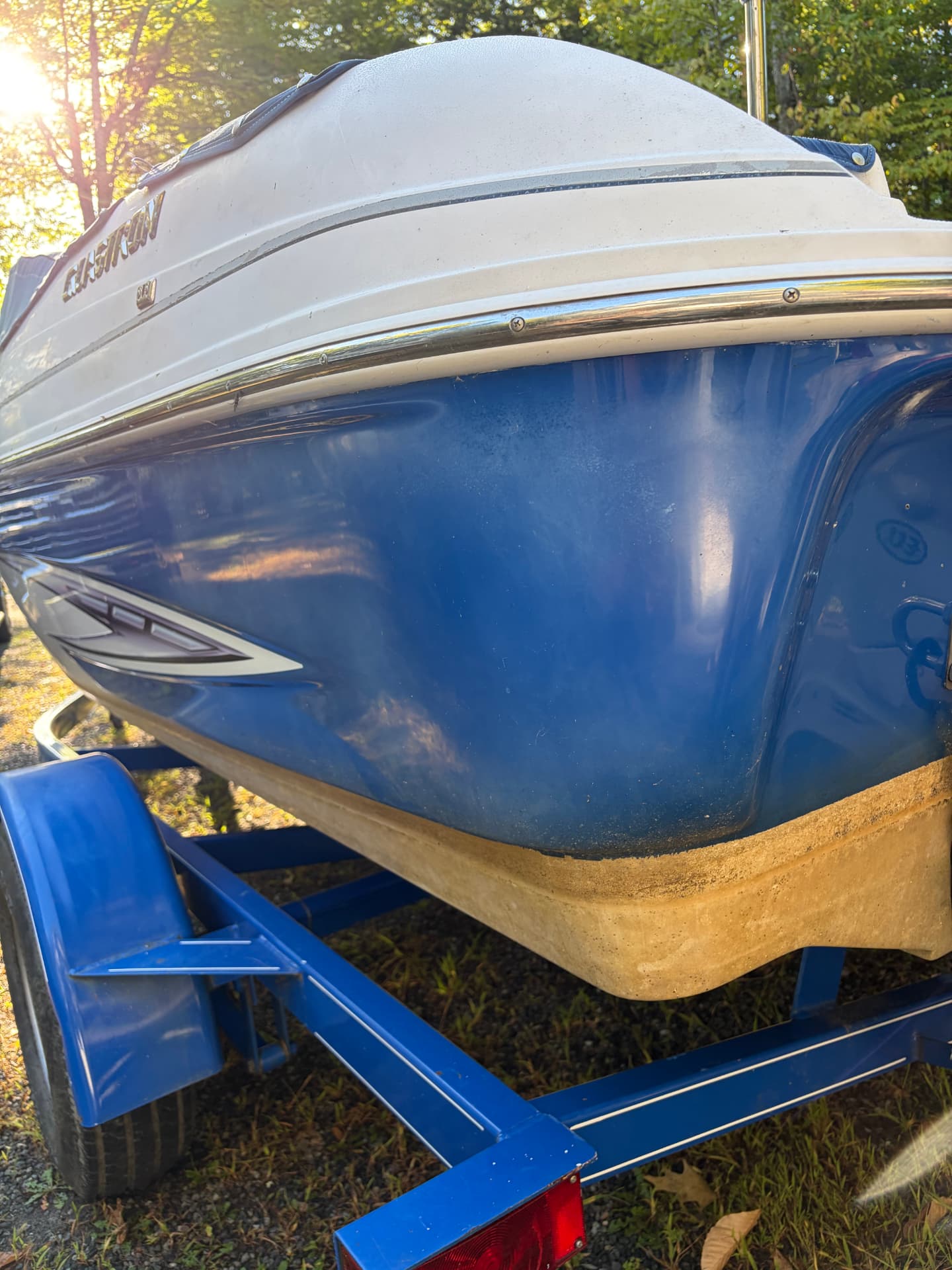 Blue Glastron hull with waterline buildup before detailing