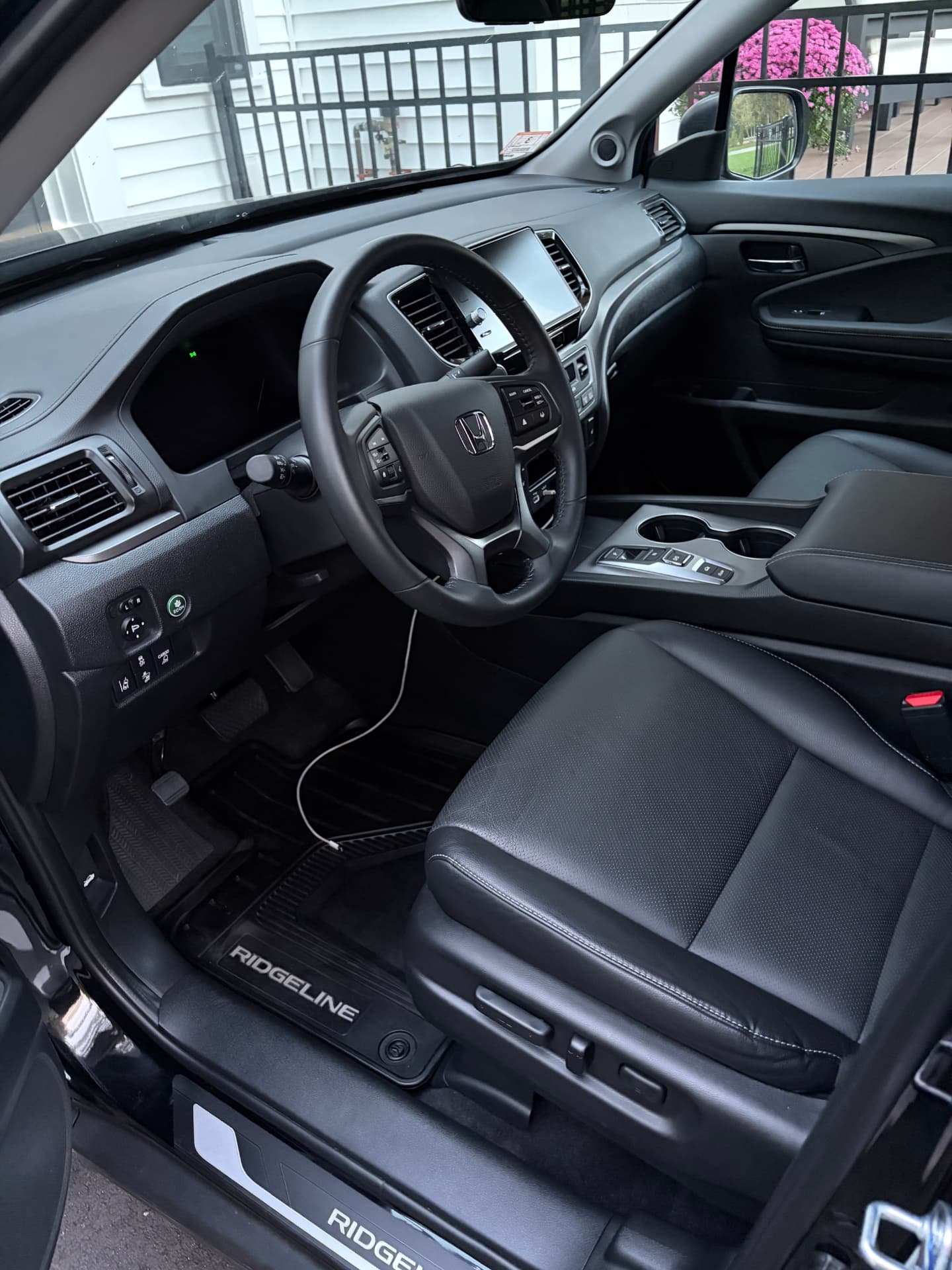 Detailed Honda Ridgeline interior with black leather and steering wheel
