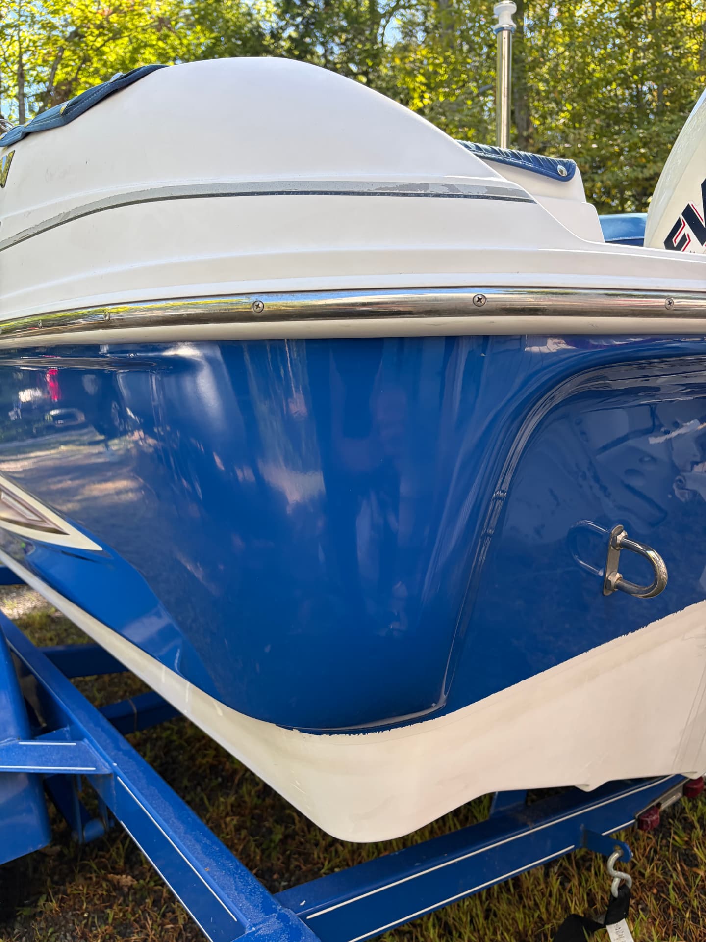 Blue Glastron hull glossy and clean after detailing