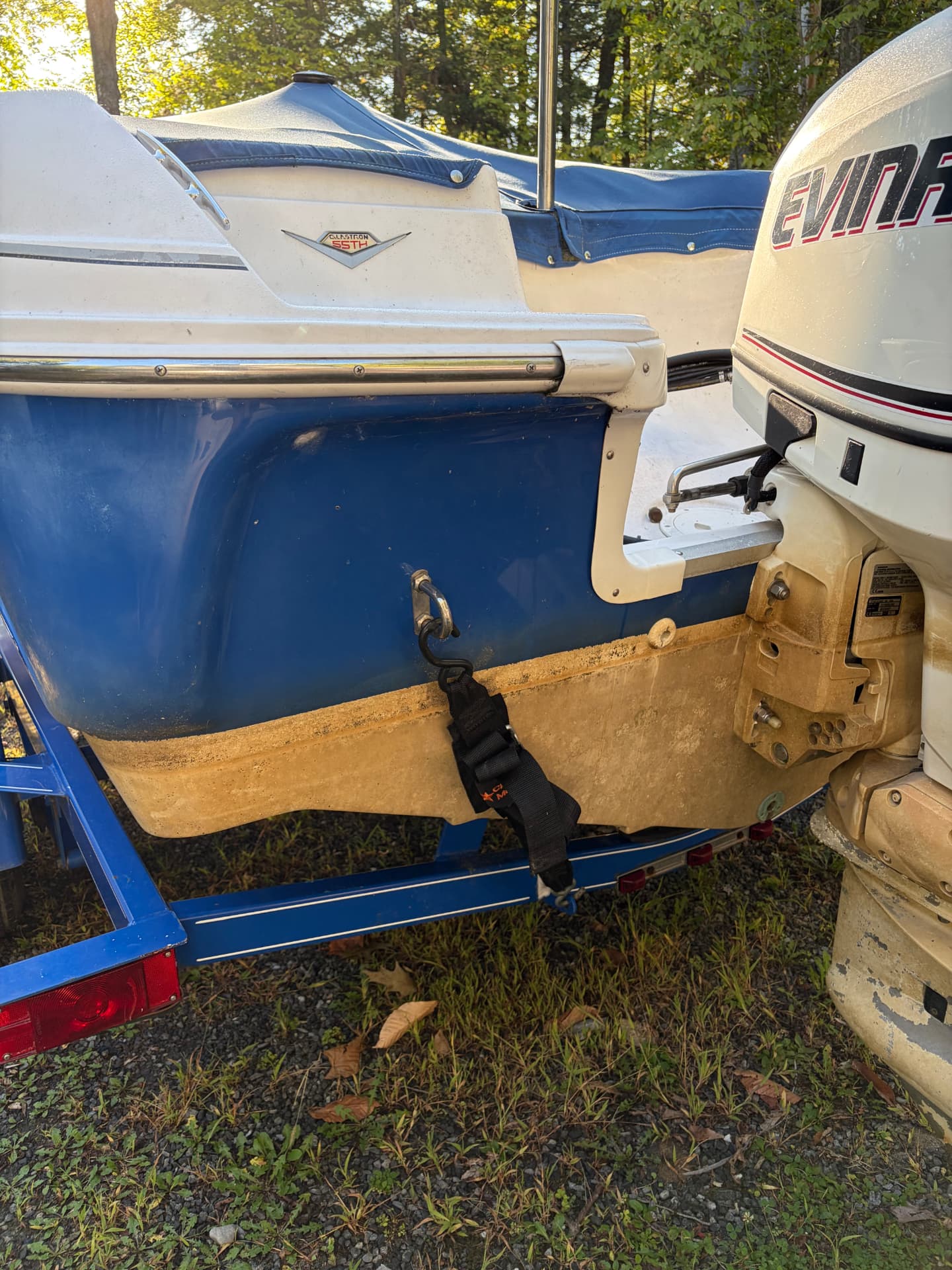 Glastron boat stern with grime and yellow staining before detailing