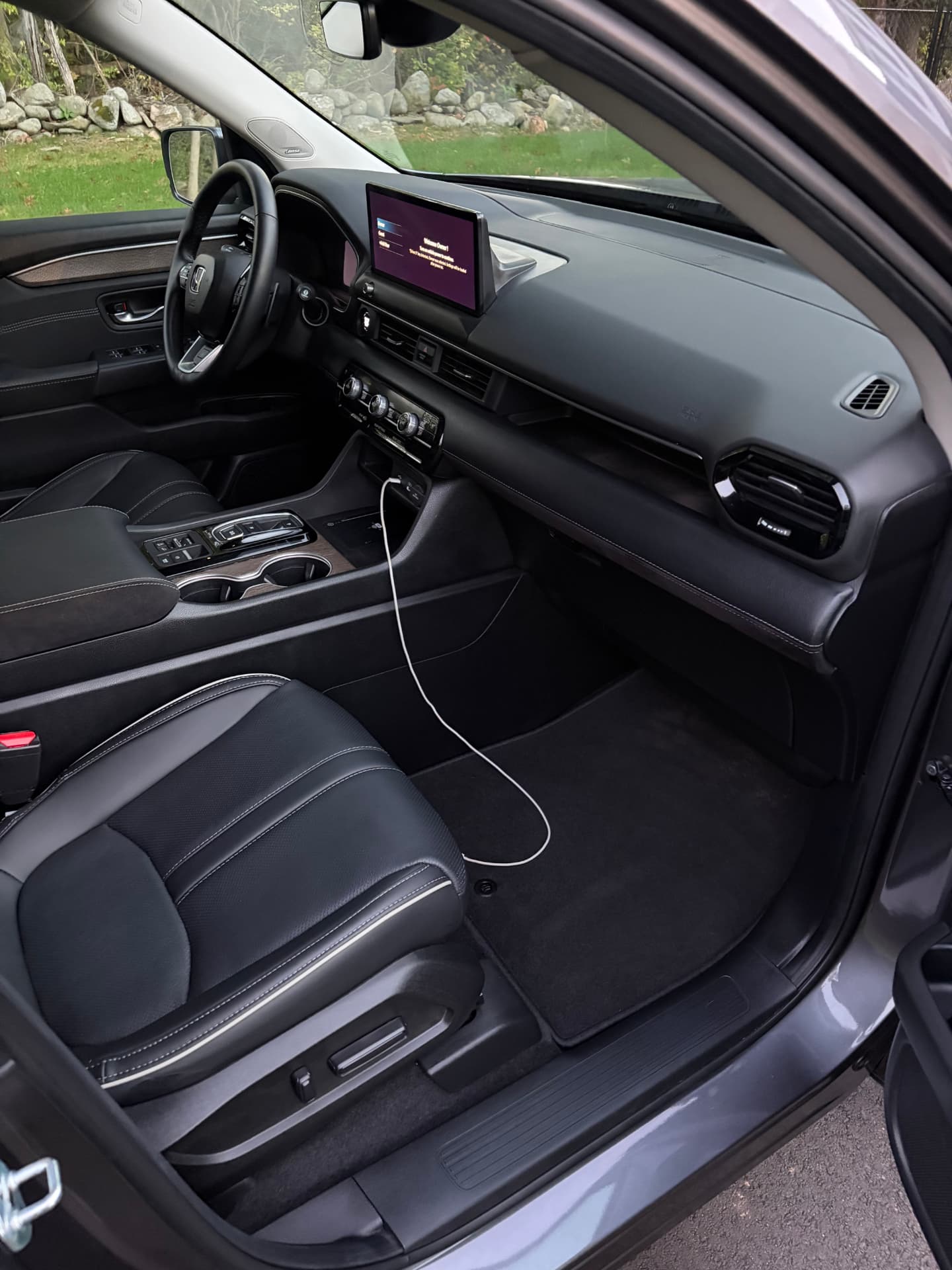 Freshly detailed Honda dashboard, console, and leather front seat
