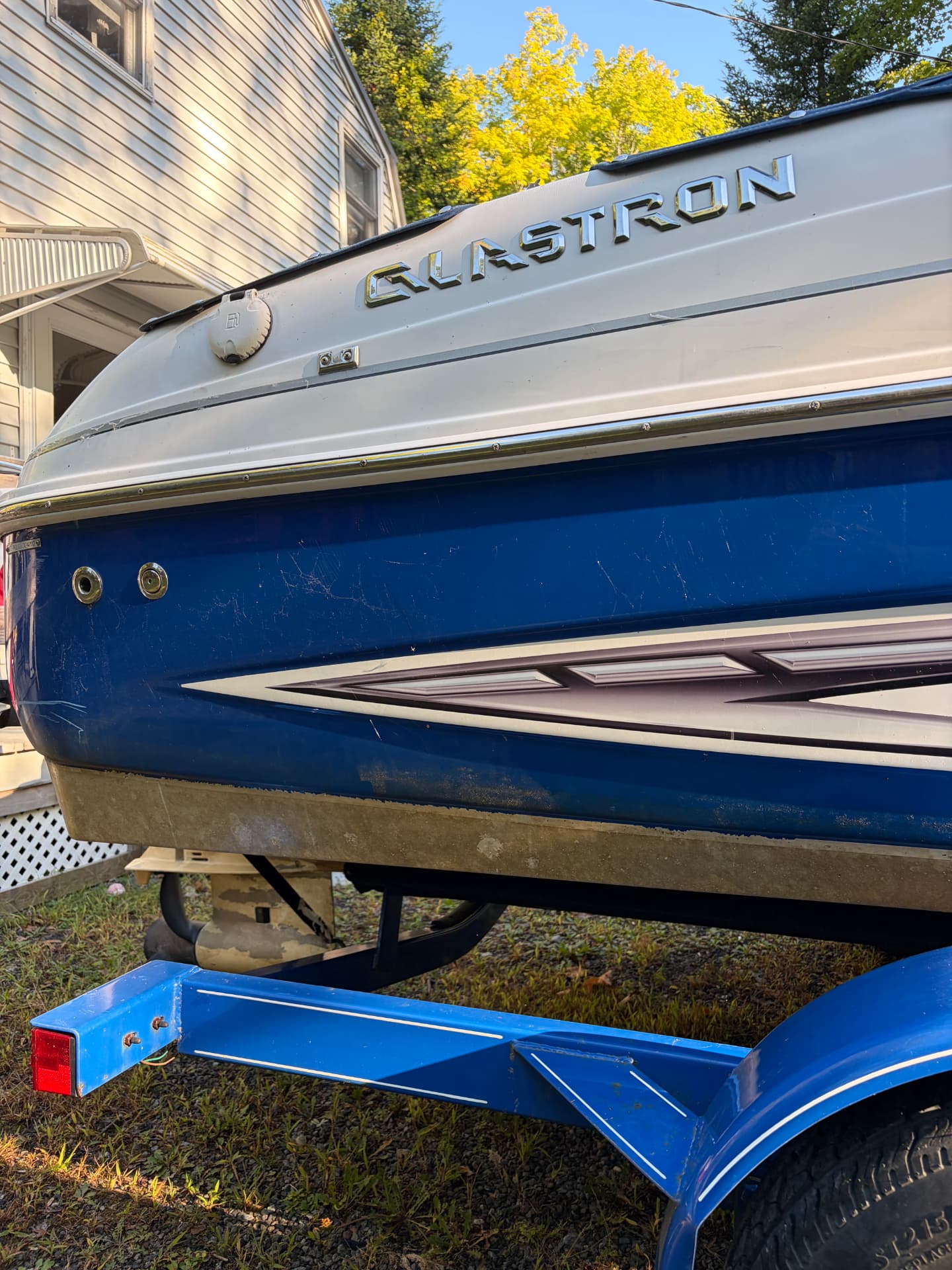Glastron boat hull with yellow waterline stains before detailing